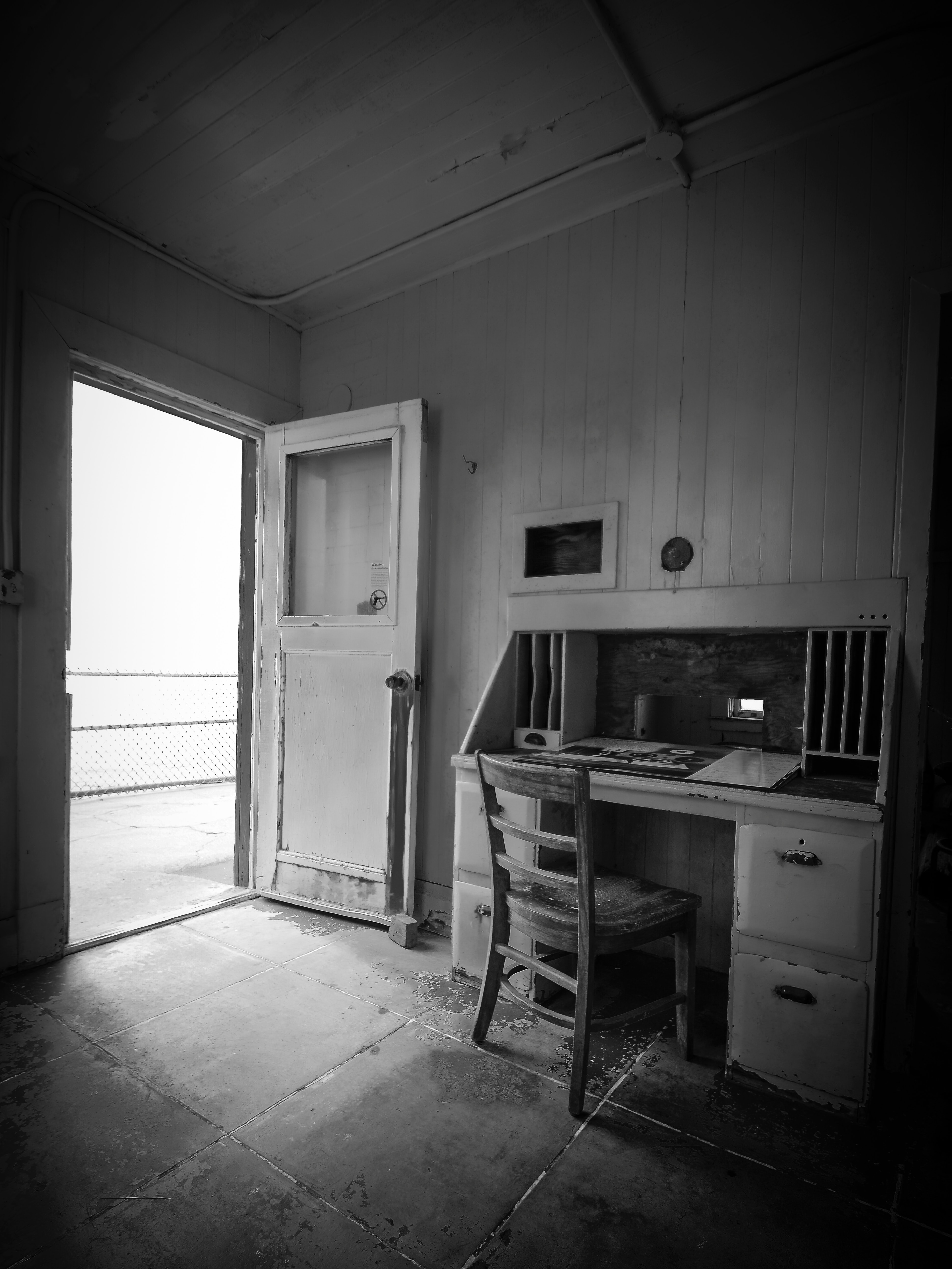 An open door in a room with a wooden desk