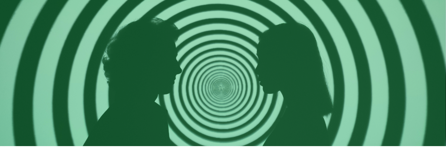 Two silhouetted people facing each other