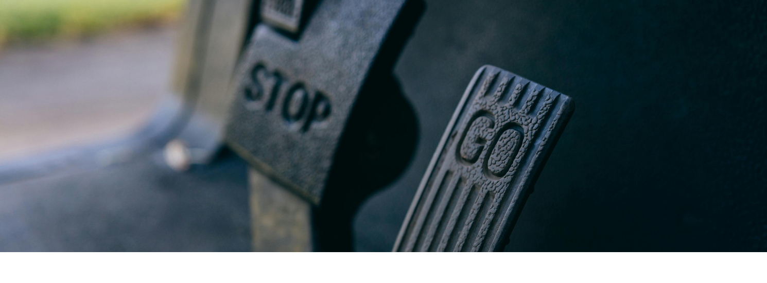 Two pedals, one with the word stop written on it, the other go