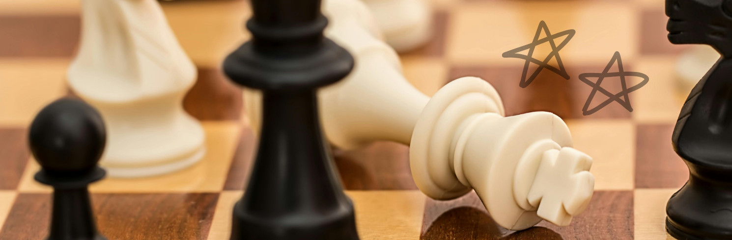 White king chess piece fallen over to show the win
