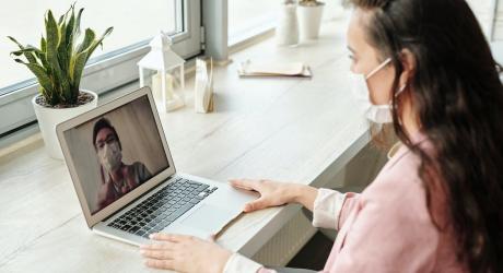 woman wearing a mask on a Zoom to a man in a mask