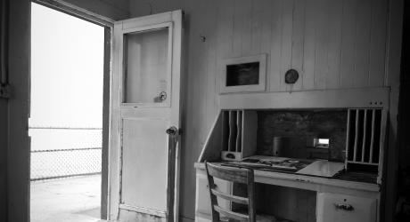 An open door in a room with a wooden desk