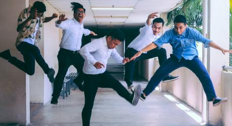 A group of people jumping in the air happily