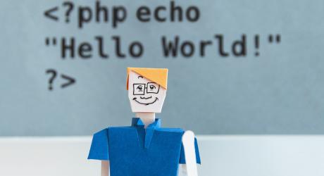 a male figure with "php echo, hello world" written on the wall behind him