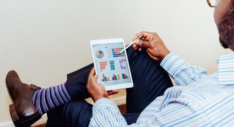 Man looking at analytics on a tablet