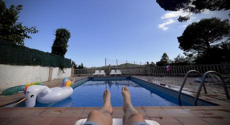 A inflatable unicorn in a swimming pool with a blue sky beyond.