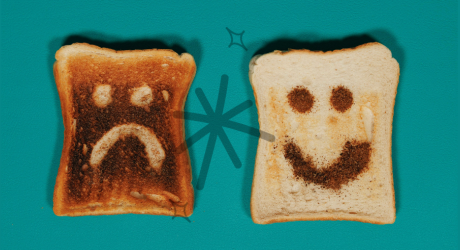 Sad face on a piece of toast next to a happy face on another piece of toast