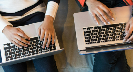 Two people with laptops