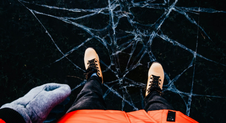 Person standing on cracks in the ice