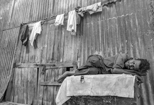A homeless man sleeping outside