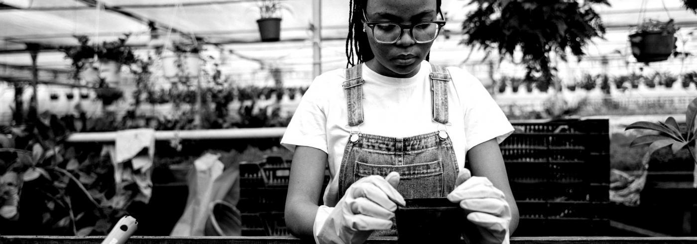 A woman tending to potted plants