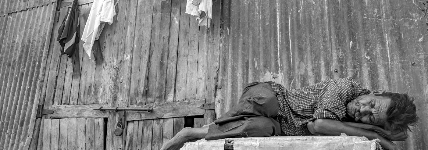 A homeless man sleeping outside