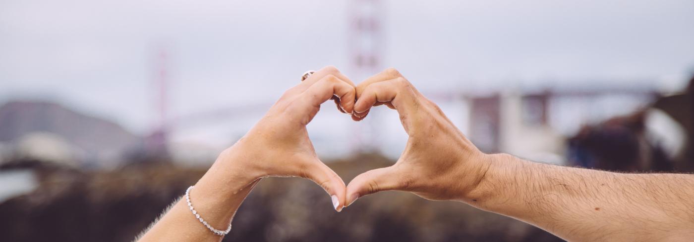 people making a heart shape with their hands