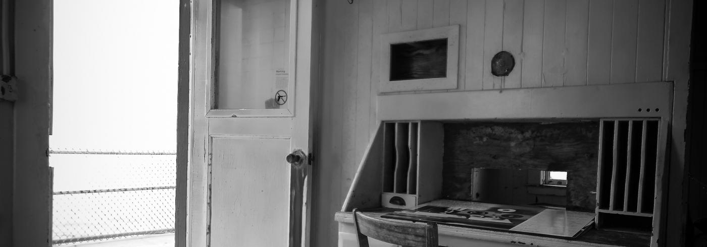 An open door in a room with a wooden desk