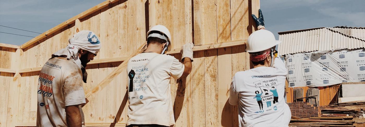 Three men building a new wall