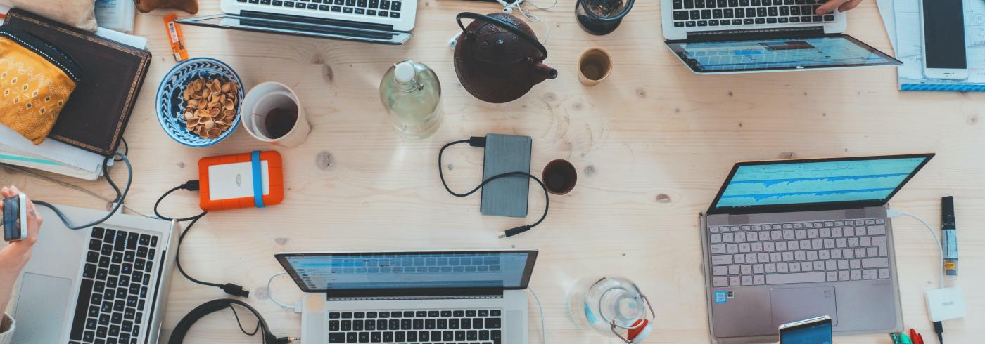 A birds eye view of a busy table of office workers