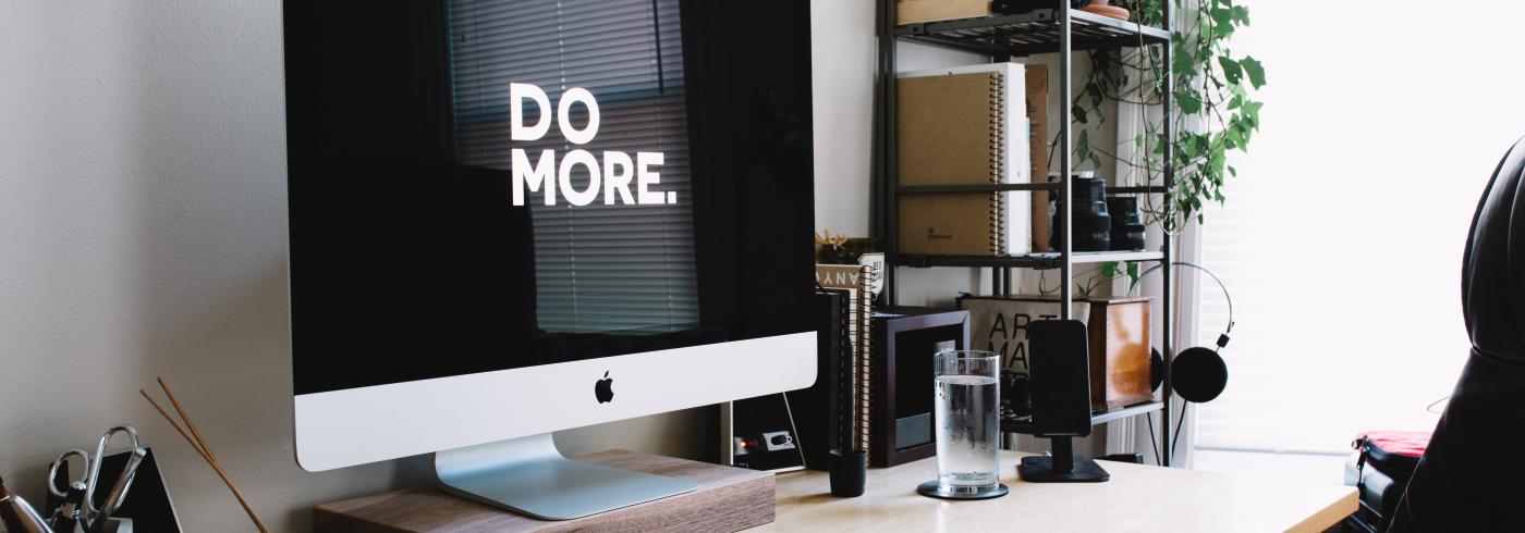 An iMac showing the phrase "do more"