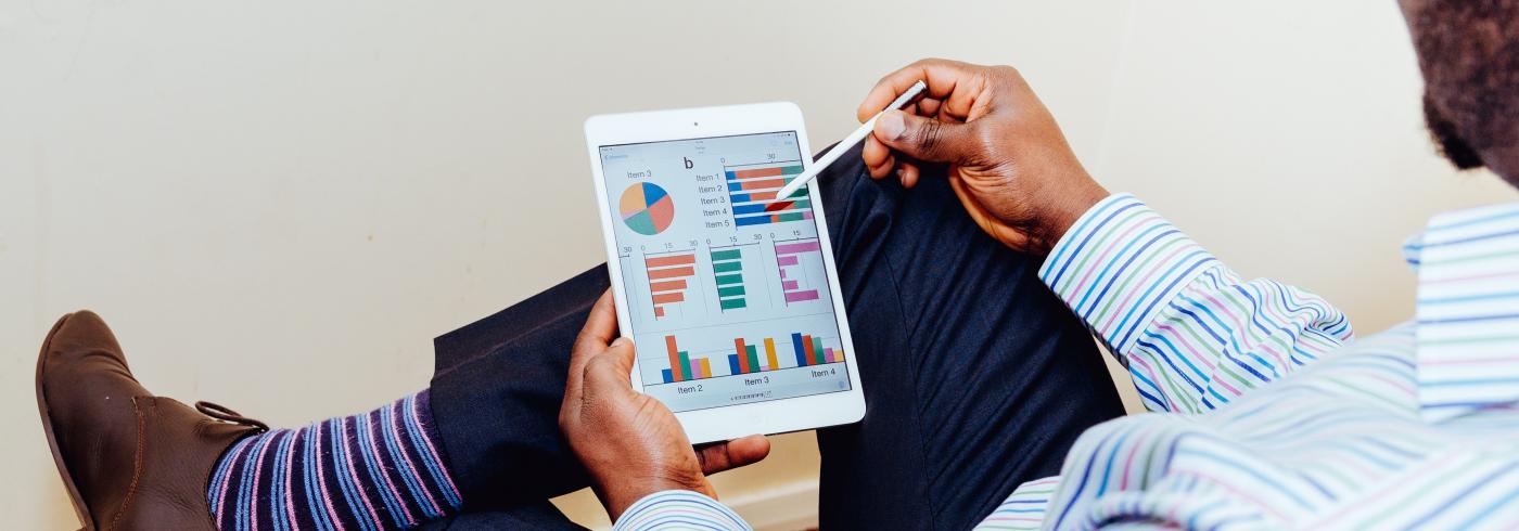 Man looking at analytics on a tablet