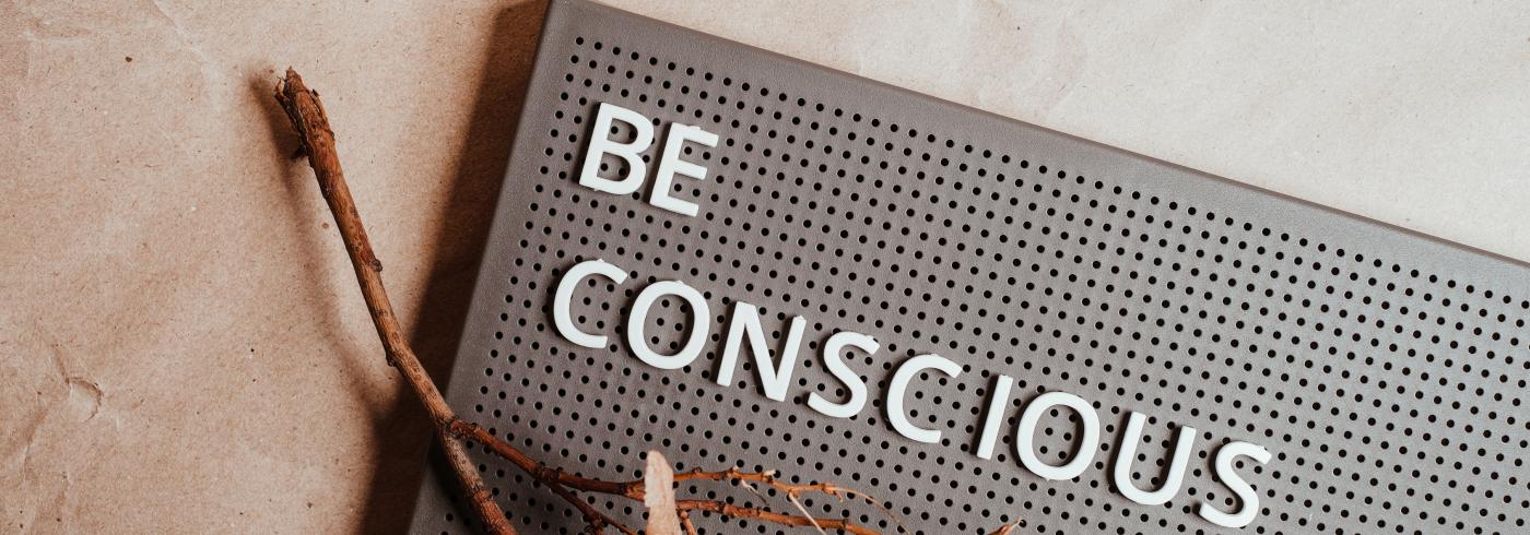 "be conscious" written on a bulletin board