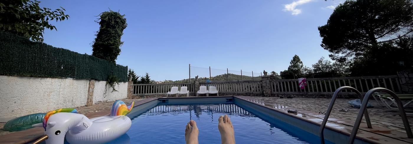 A inflatable unicorn in a swimming pool with a blue sky beyond.