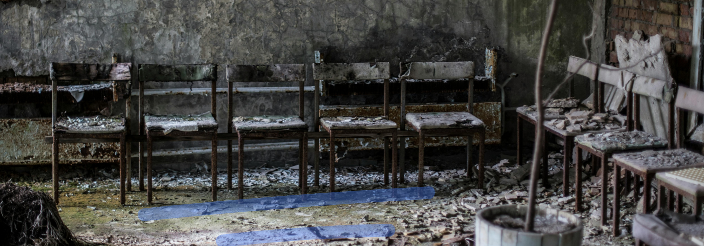 Row of rotten wooden chairs