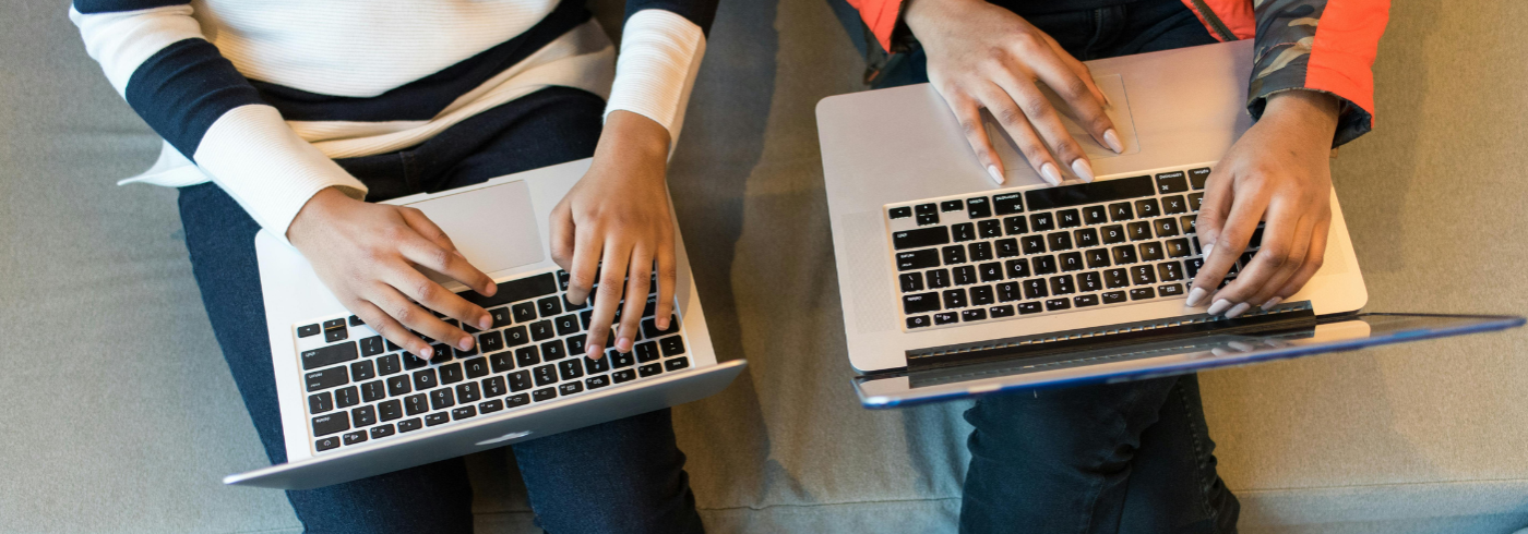 Two people with laptops