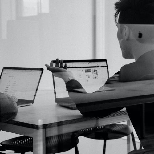 two people at laptops